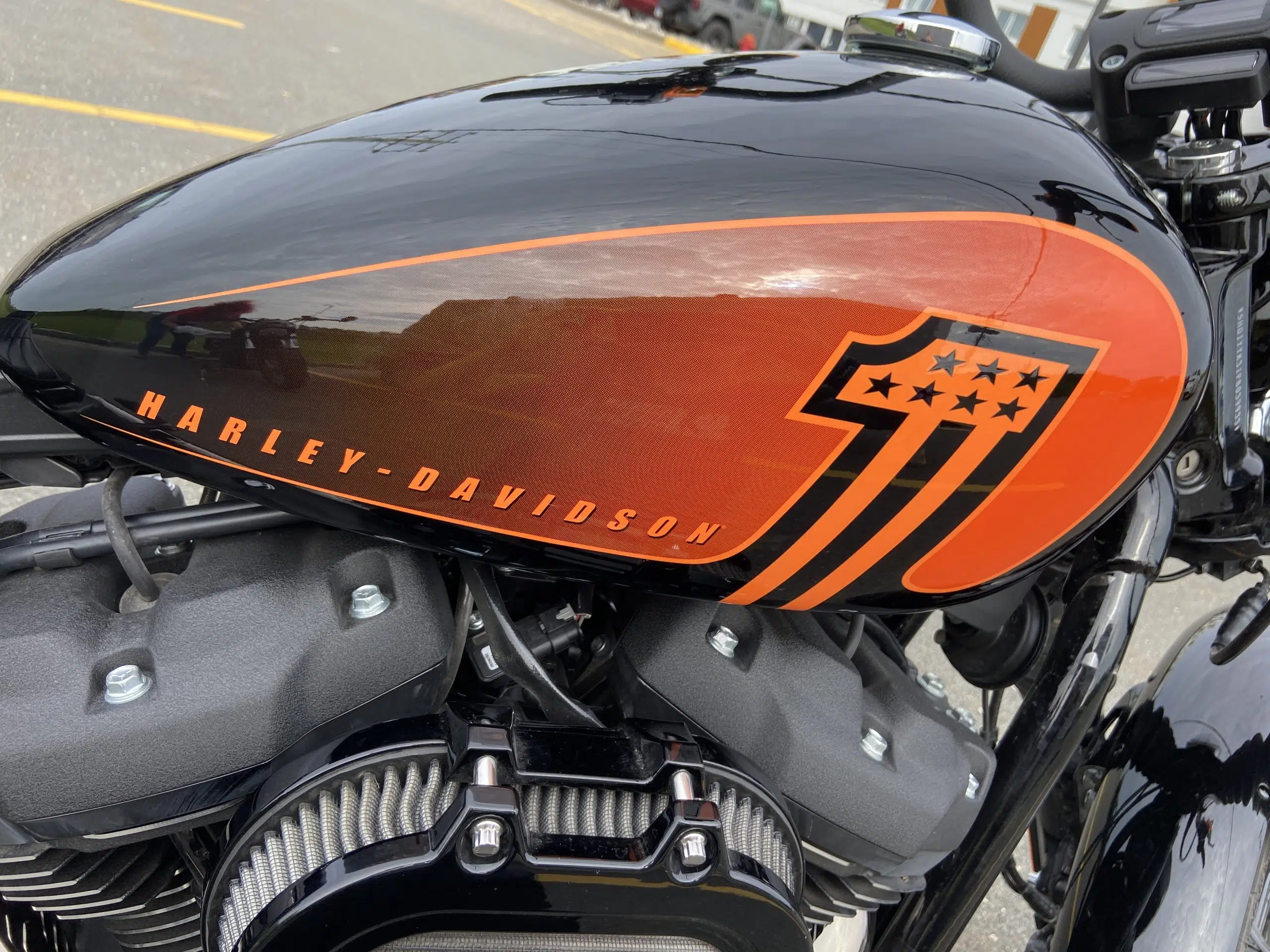 The orange patterns on the vivd black motorcycle are a reminder of the iconic Harley color